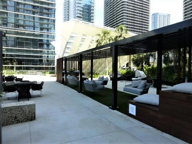 a view of a patio with couches and potted plants