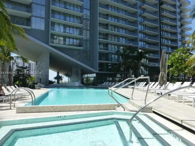 a view of a swimming pool with a lounge chairs