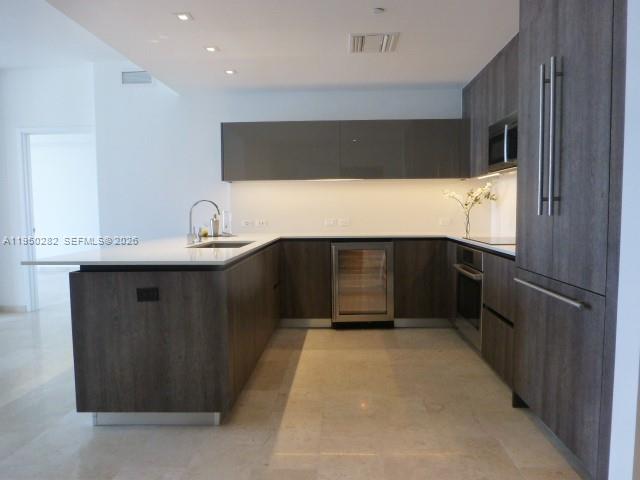 88 Southwest 7th Street, Unit 2203 Miami, FL 33130 - Photo 4 of 37 a kitchen with stainless steel appliances a refrigerator and a sink