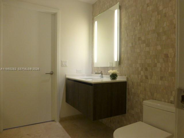 88 Southwest 7th Street, Unit 2203 Miami, FL 33130 - Photo 8 of 37 a bathroom with a sink vanity mirror and toilet