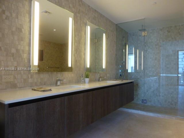 88 Southwest 7th Street, Unit 2203 Miami, FL 33130 - Photo 10 of 37 a bathroom with double sink and a mirror