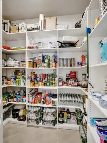 a bedroom with a bed couch and a large window