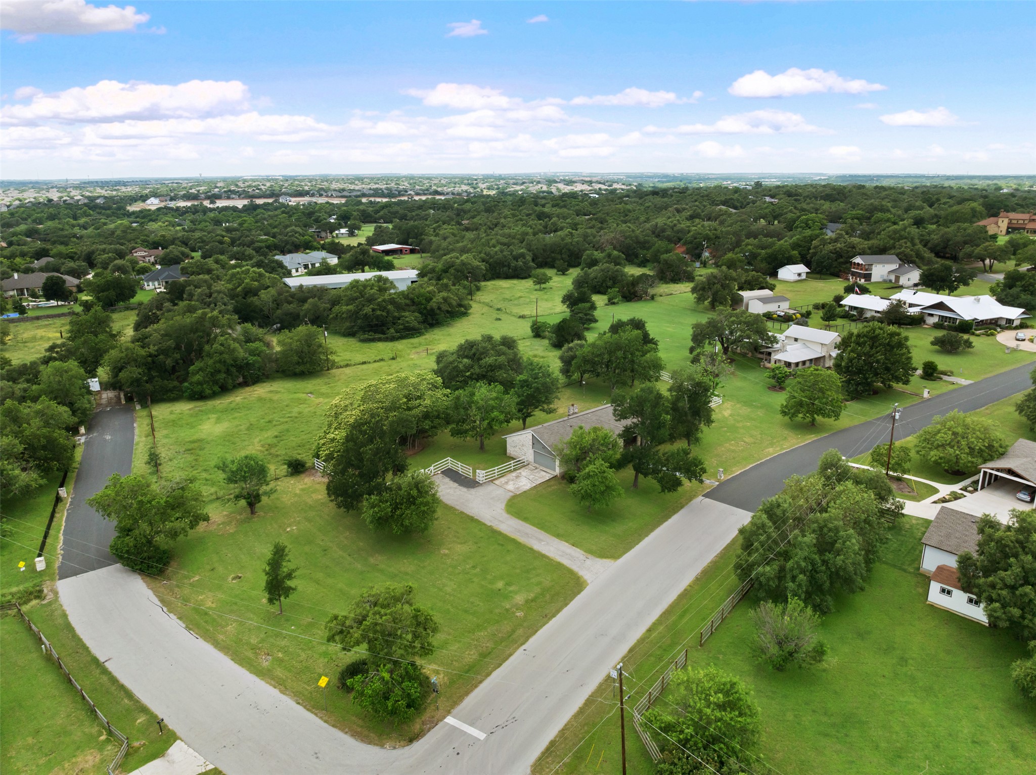 1600 Pin Oak Lane Round Rock, TX 78681 - Photo 36 of 40 Aerial perspective showcasing a residential property with a light-colored exterior and a dark roof, situated on a verdant lot