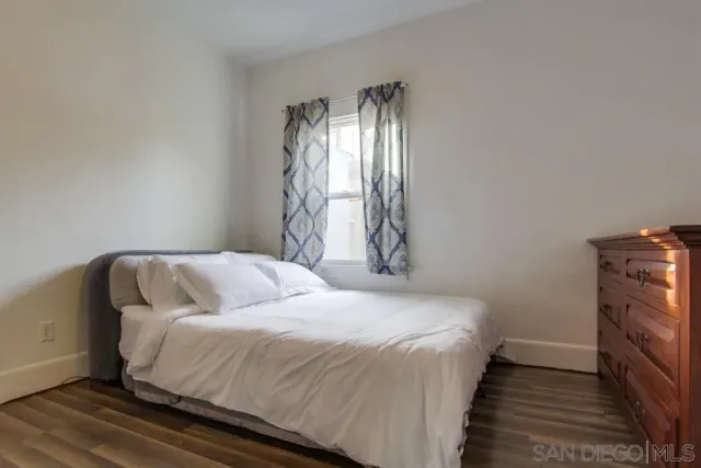 a bedroom with a bed and a tv