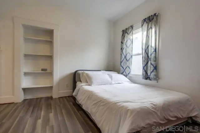 a bedroom with a bed and a window