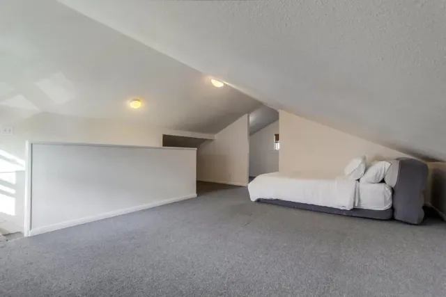 a spacious bedroom with a bed