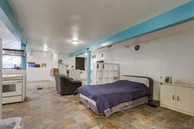 a large bedroom with a bed and cabinets