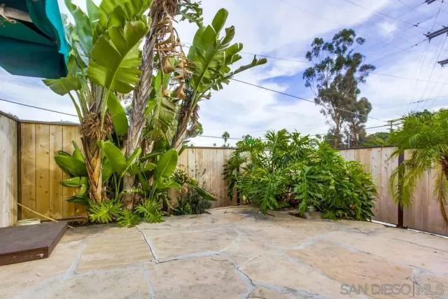 a view of a chairs and table in backyard