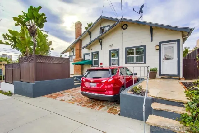 a front view of a house with a garden