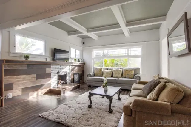 a living room with furniture fireplace and a flat screen tv