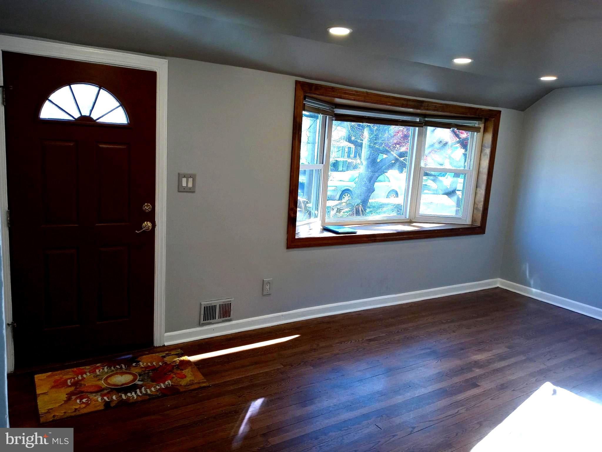 12616 Epping Road Silver Spring, MD 20906 - Photo 3 of 28 an empty room with wooden floor and windows
