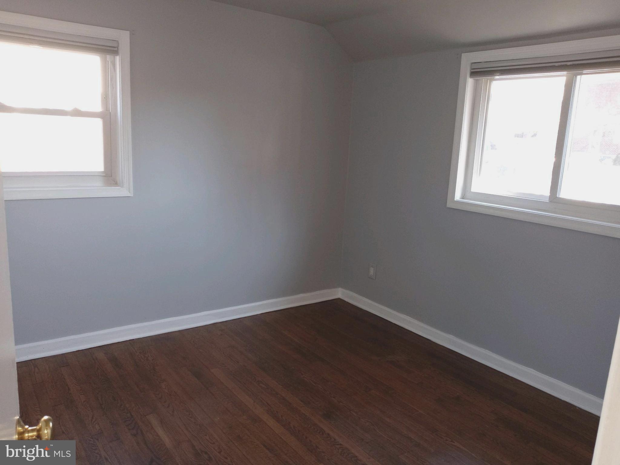 12616 Epping Road Silver Spring, MD 20906 - Photo 9 of 28 an empty room with wooden floor and windows