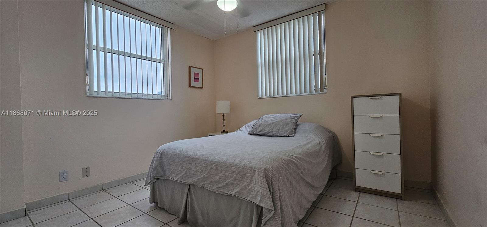 501 Southwest 1st Street, Unit 507 Miami, FL 33130 - Photo 12 of 25 a bedroom with a bed and a window