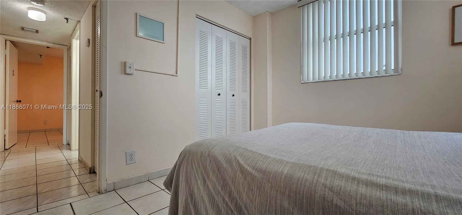 501 Southwest 1st Street, Unit 507 Miami, FL 33130 - Photo 13 of 25 a bedroom with a bed and a window