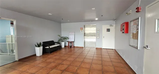 a view of kitchen with furniture and an empty room