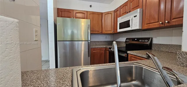 a kitchen with a refrigerator and a microwave