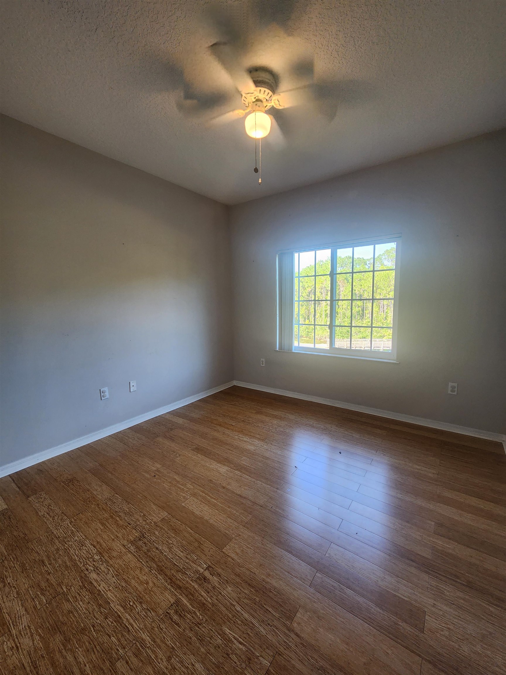510 Florida Club Boulevard, Unit 304 St. Augustine, FL 32084 - Photo 15 of 24 a view of an empty room with window and wooden floor