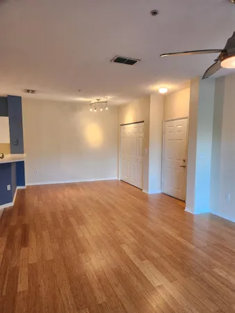 a view of empty room with wooden floor