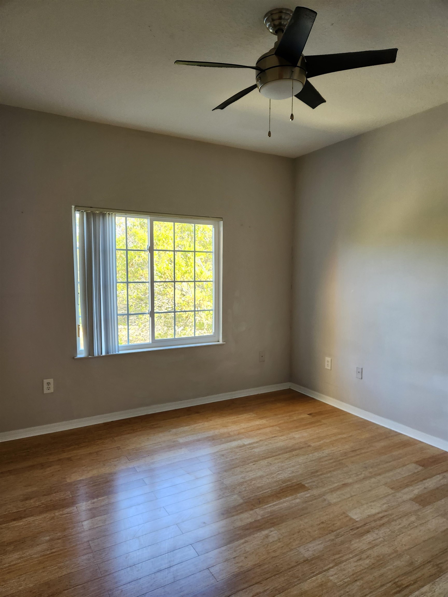 510 Florida Club Boulevard, Unit 304 St. Augustine, FL 32084 - Photo 10 of 24 an empty room with wooden floor and windows