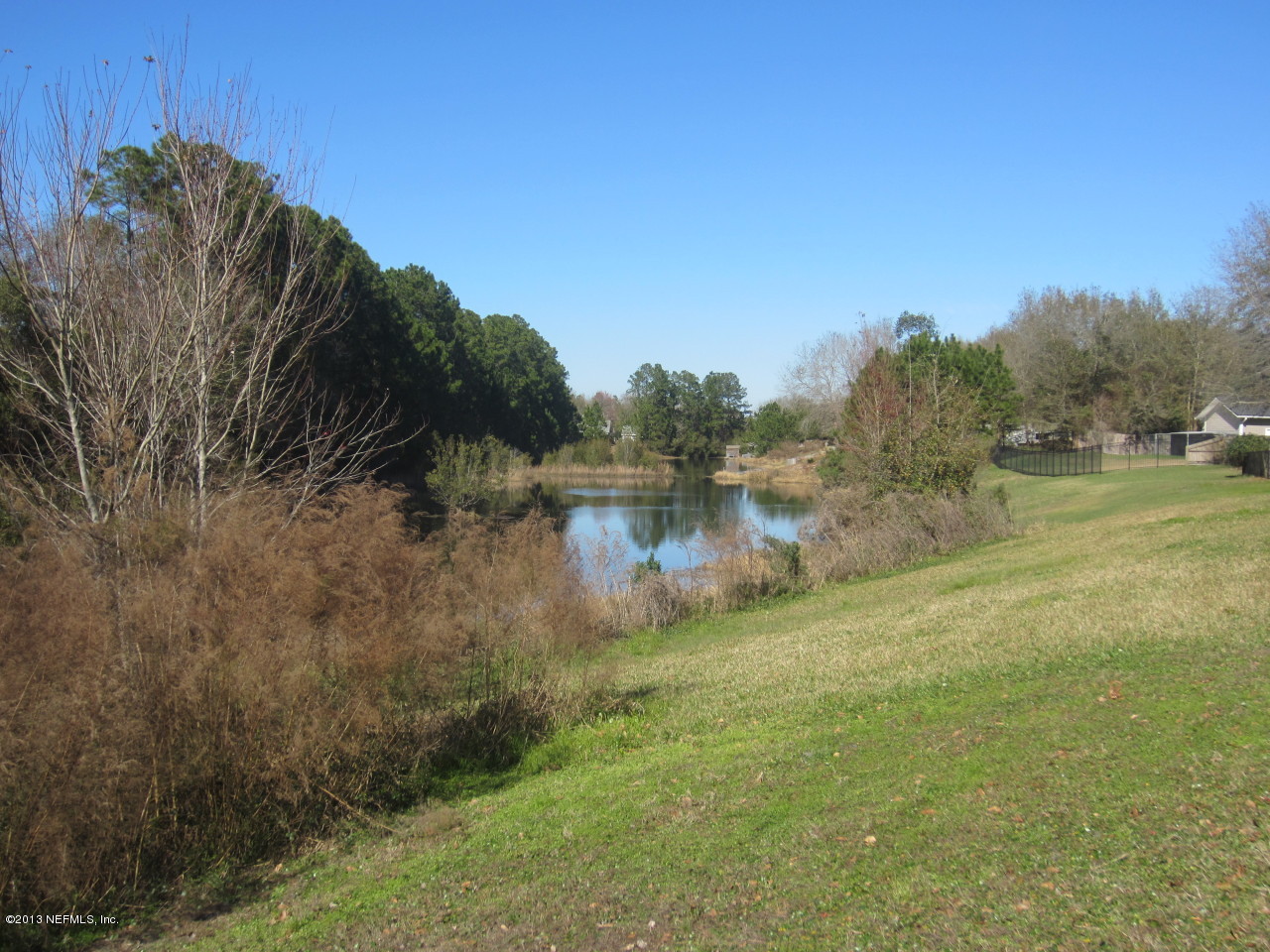 1050 Cactus Cut Road Middleburg, FL 32068 - Photo 12 of 54 a view of a lake with a yard