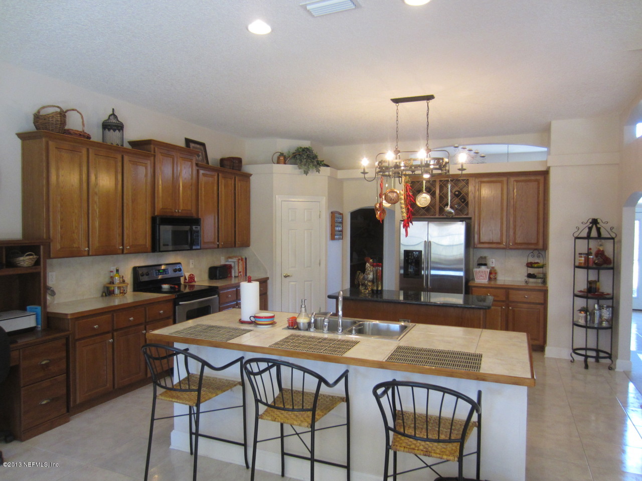 1050 Cactus Cut Road Middleburg, FL 32068 - Photo 18 of 54 a kitchen with granite countertop a sink cabinets and stainless steel appliances