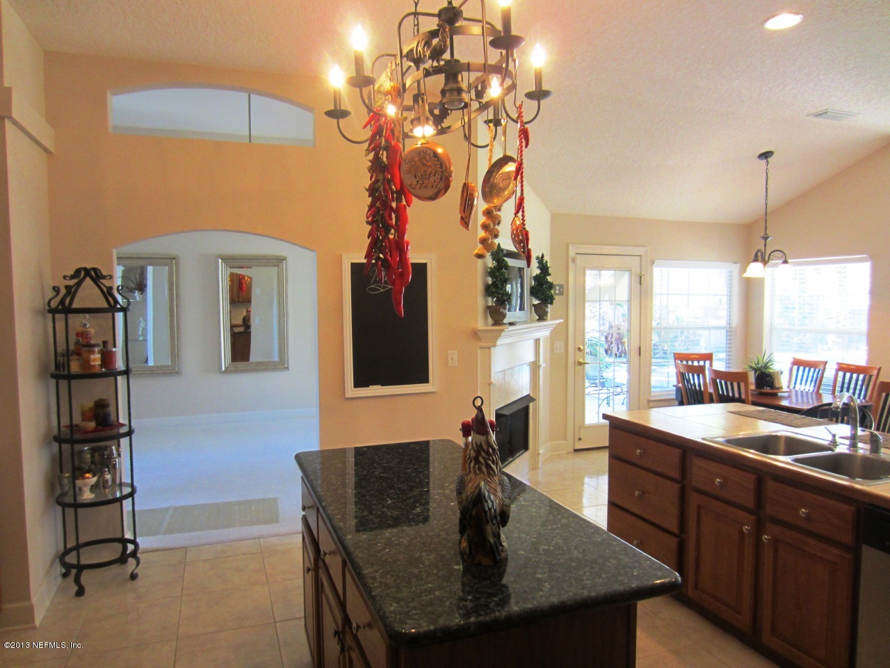 1050 Cactus Cut Road Middleburg, FL 32068 - Photo 19 of 54 a kitchen with a table chairs and chandelier