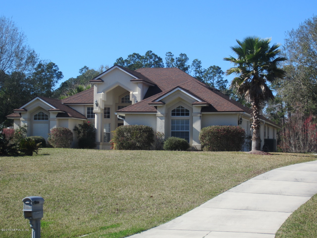 1050 Cactus Cut Road Middleburg, FL 32068 - Photo 2 of 54 a front view of a house with a yard and garage