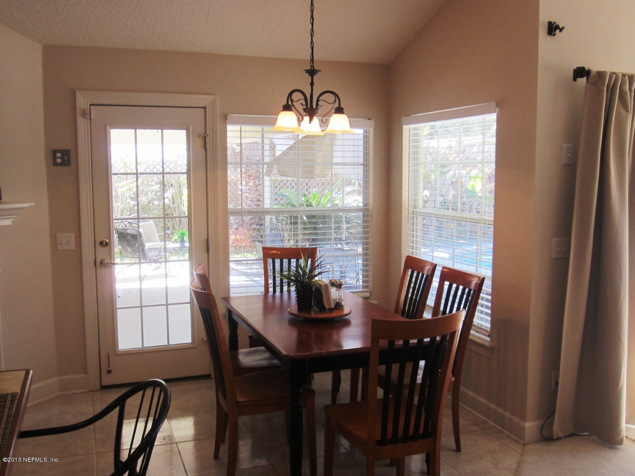 1050 Cactus Cut Road Middleburg, FL 32068 - Photo 21 of 54 a dining room with furniture a chandelier and wooden floor