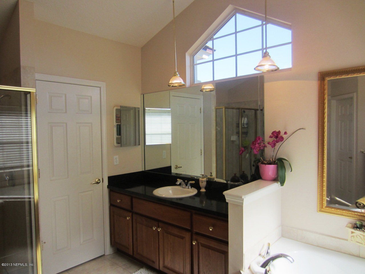 1050 Cactus Cut Road Middleburg, FL 32068 - Photo 30 of 54 a bathroom with a sink vanity and a mirror