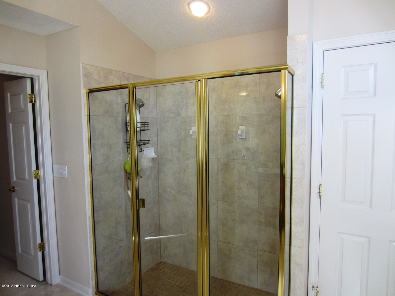 1050 Cactus Cut Road Middleburg, FL 32068 - Photo 32 of 54 a bathroom with a glass shower door