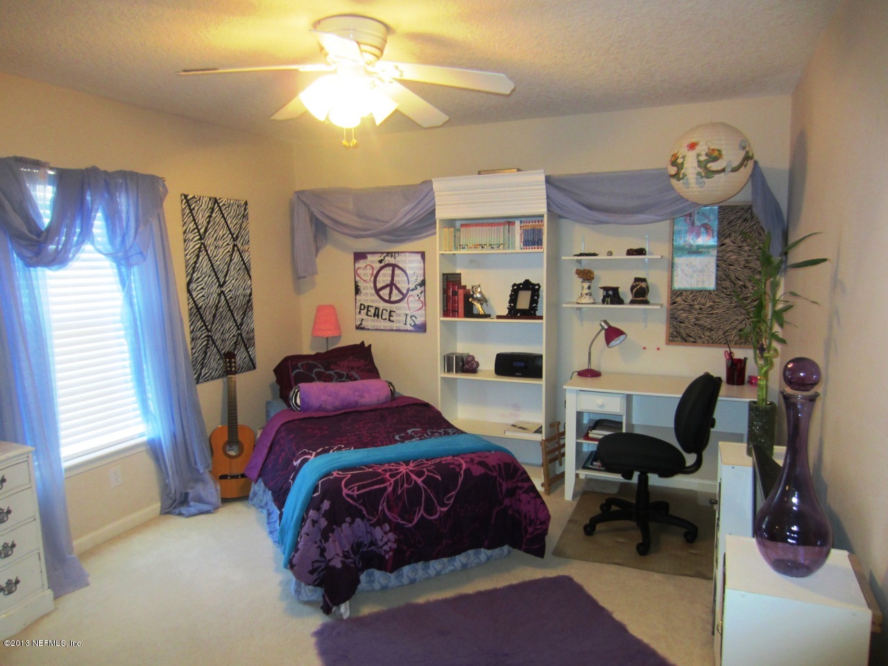 1050 Cactus Cut Road Middleburg, FL 32068 - Photo 34 of 54 a bedroom with a bed and a chandelier