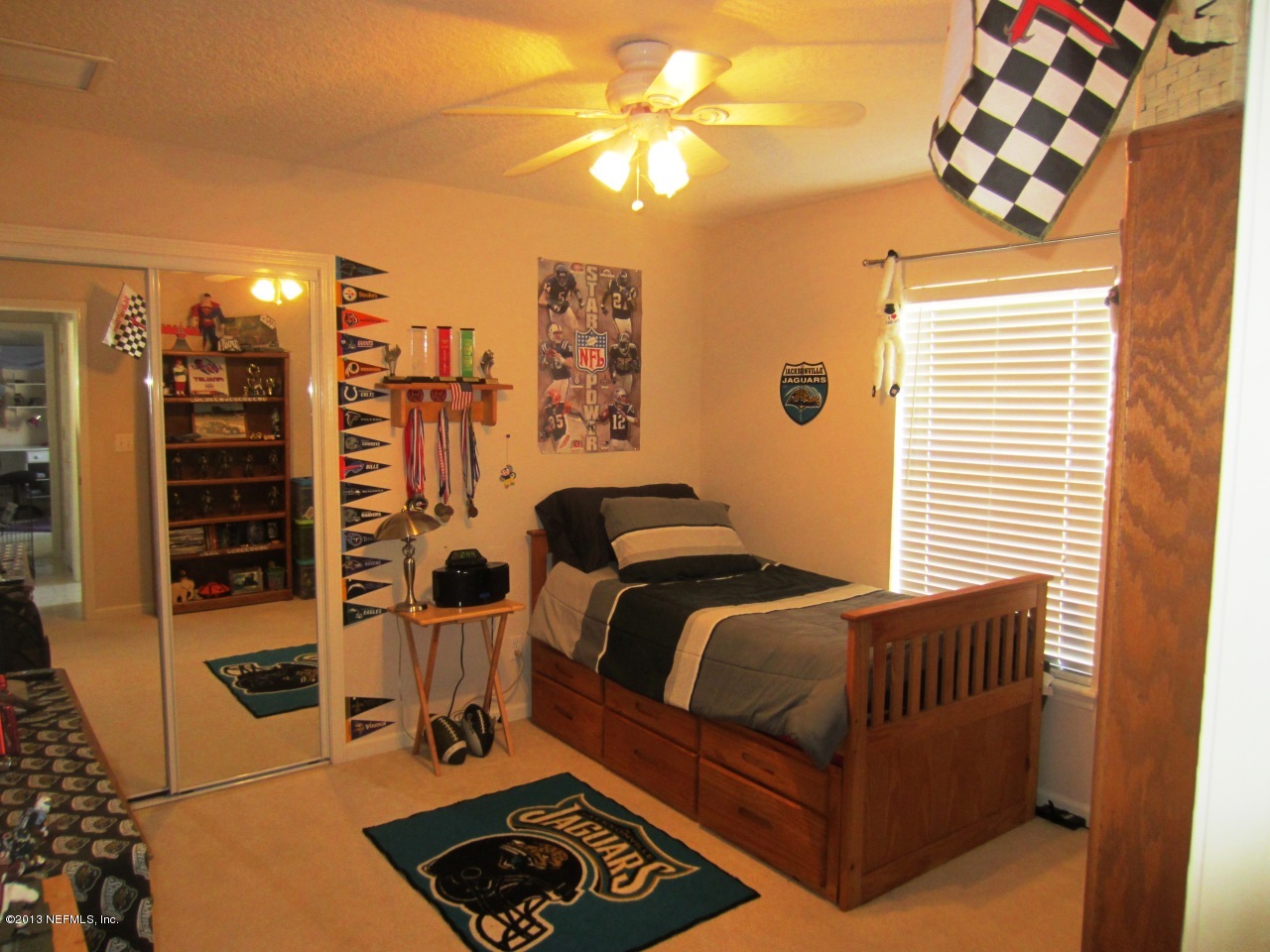 1050 Cactus Cut Road Middleburg, FL 32068 - Photo 35 of 54 a bedroom with a bed and a chandelier