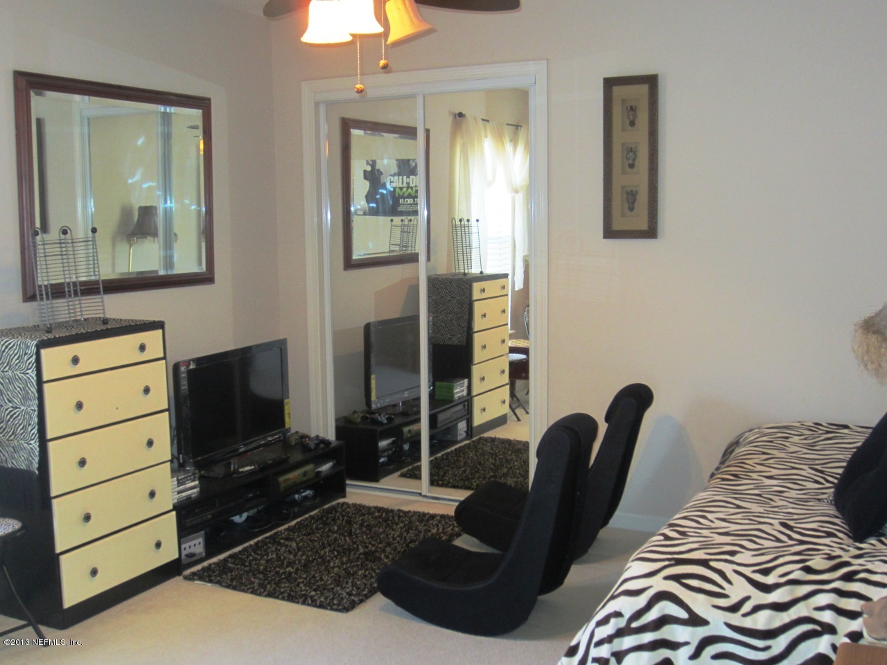 1050 Cactus Cut Road Middleburg, FL 32068 - Photo 36 of 54 a bedroom with a bed and a chair