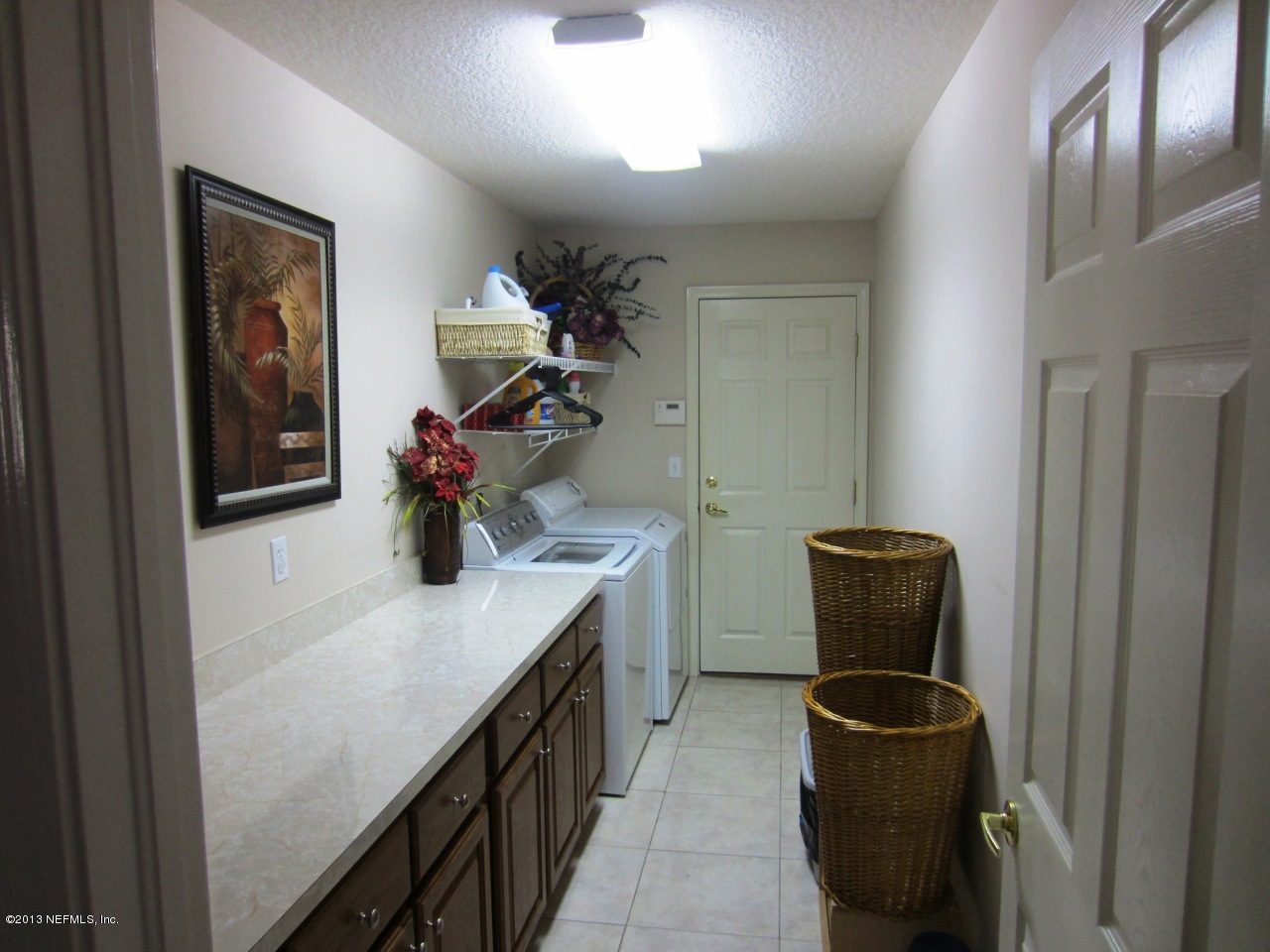 1050 Cactus Cut Road Middleburg, FL 32068 - Photo 38 of 54 a kitchen with a sink and a refrigerator