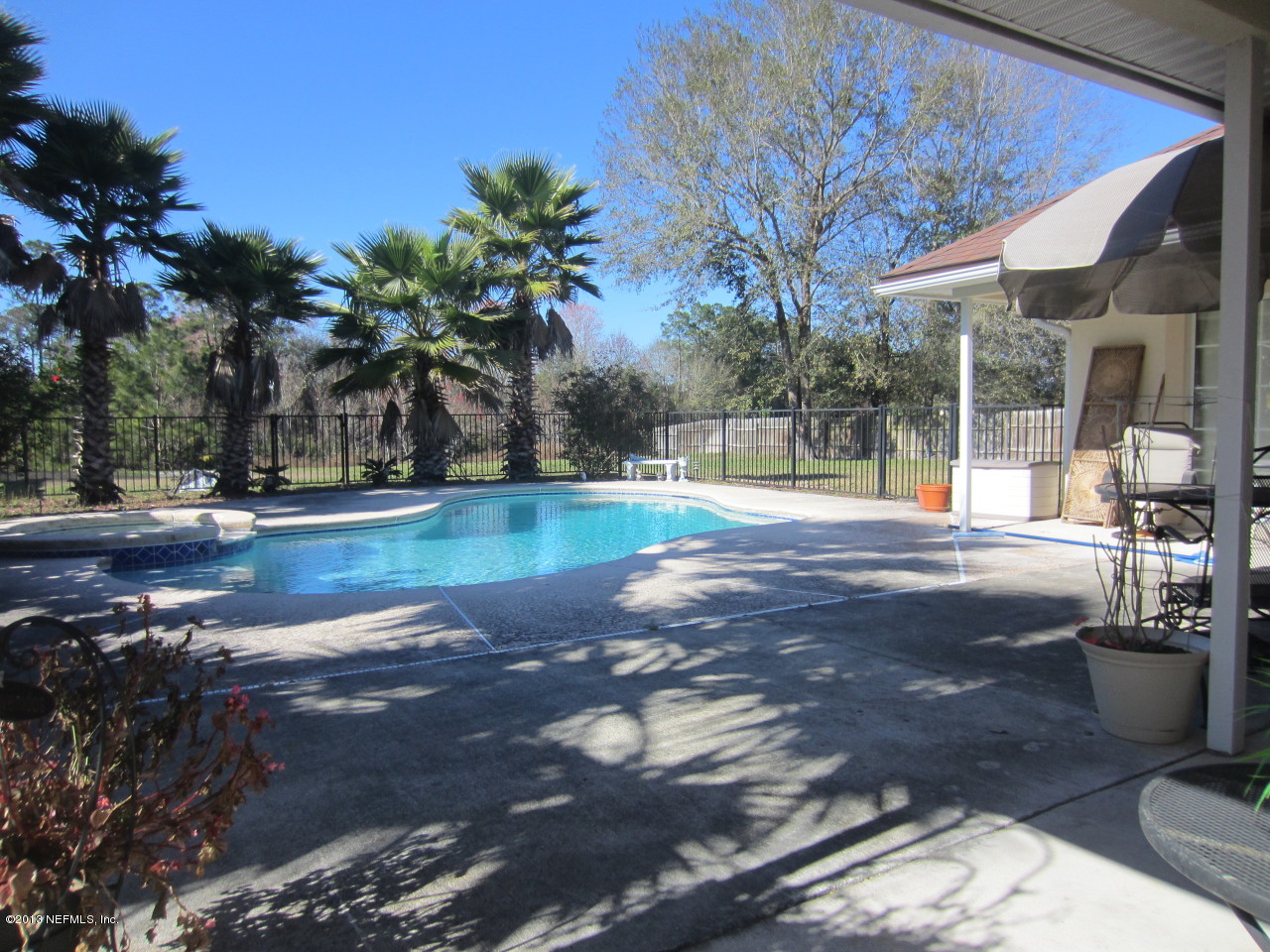 1050 Cactus Cut Road Middleburg, FL 32068 - Photo 8 of 54 a swimming pool with outdoor seating and yard