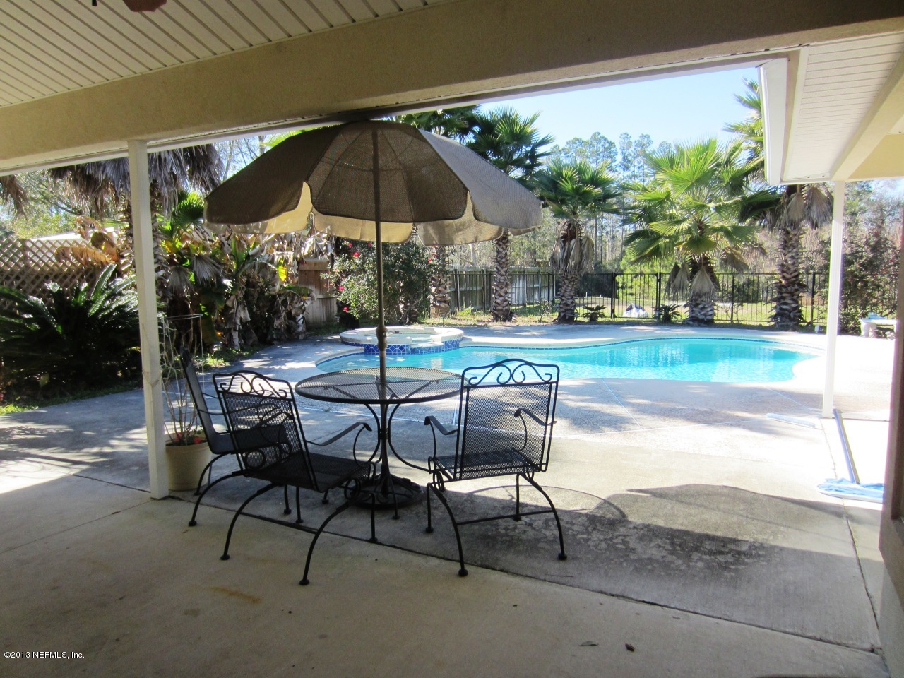 1050 Cactus Cut Road Middleburg, FL 32068 - Photo 9 of 54 a patio with a yard table and chairs