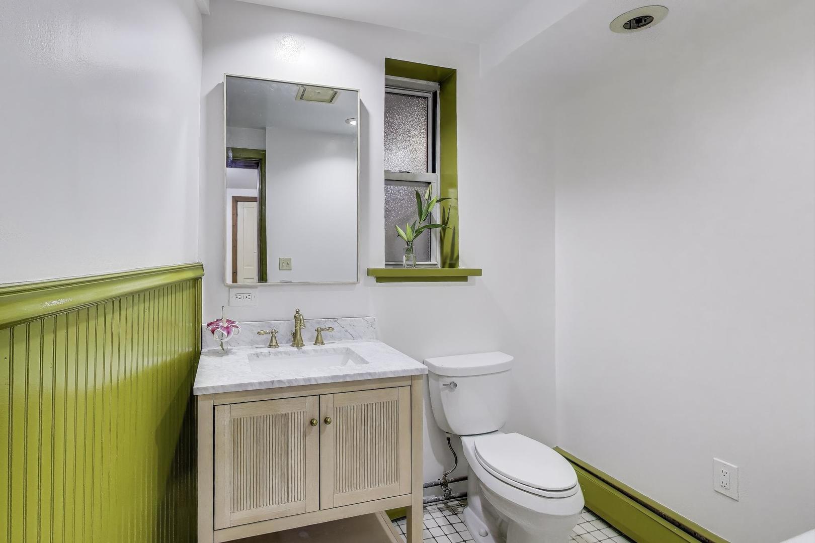 1951 West Evergreen Avenue Chicago, IL 60622 - Photo 25 of 29 a bathroom with a granite countertop toilet sink and mirror