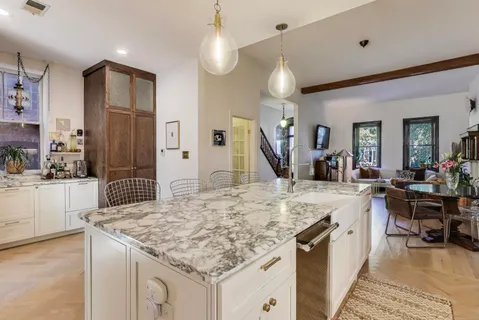 a large kitchen with kitchen island a sink stove and refrigerator