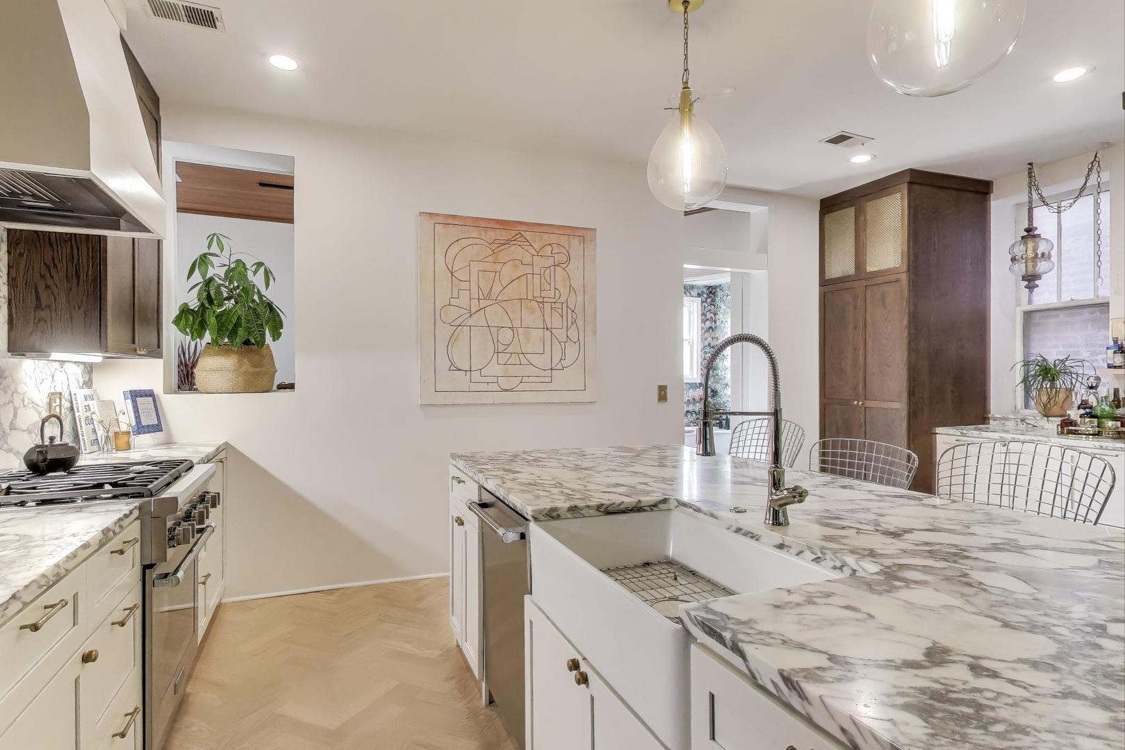 1951 West Evergreen Avenue Chicago, IL 60622 - Photo 9 of 29 a kitchen with granite countertop a sink a stove and cabinets