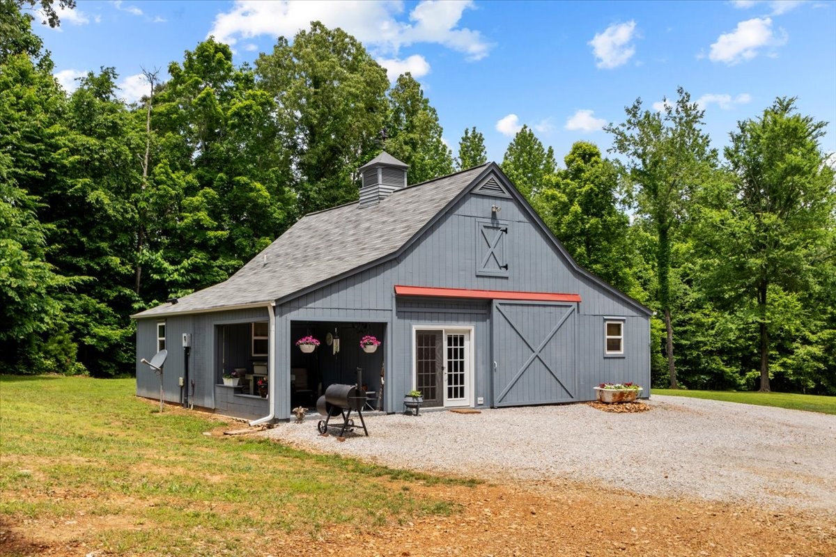 100 Croff Lane McEwen, TN 37101 - Photo 28 of 63 a front view of a house with a yard and garage