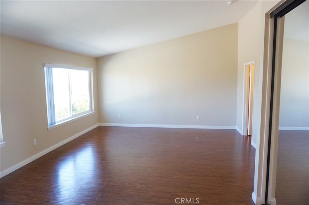 19584 Shadow Glen Circle Porter Ranch, CA 91326 - Photo 24 of 72 a view of an empty room with wooden floor and a window