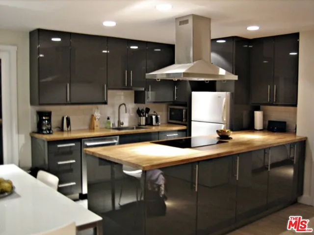 a kitchen with stainless steel appliances granite countertop a sink and a stove