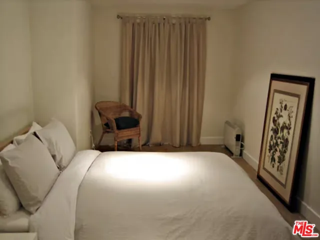 a bedroom with a bed and a chair