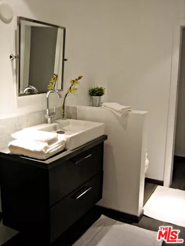 a bathroom with a sink and a mirror