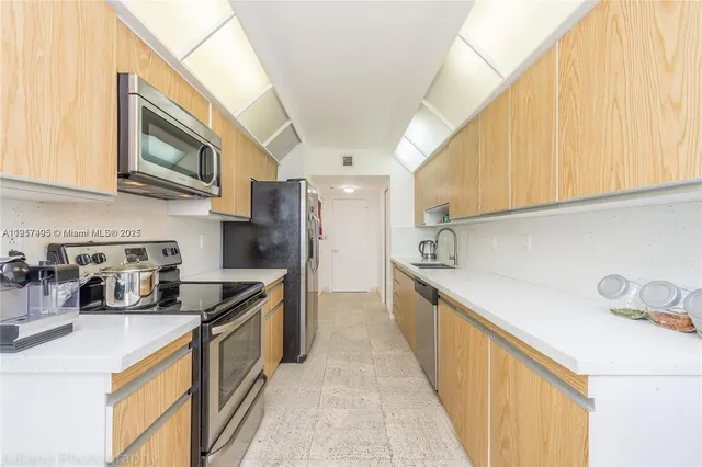 a kitchen with stainless steel appliances granite countertop a sink and cabinets