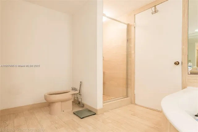 a bathroom with a toilet and a shower