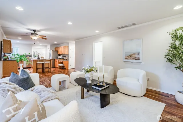 a living room with furniture a chandelier and a dining table