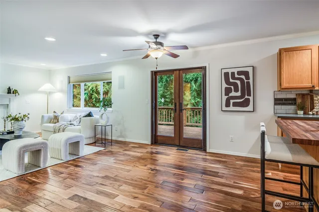 a living room with furniture a window and a flat screen tv