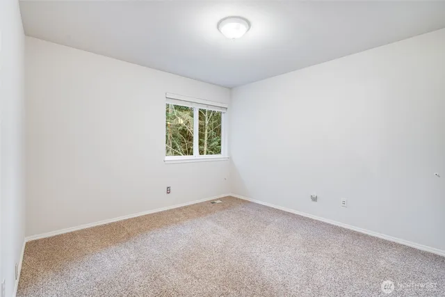 a bathroom with a double vanity sink toilet and a mirror