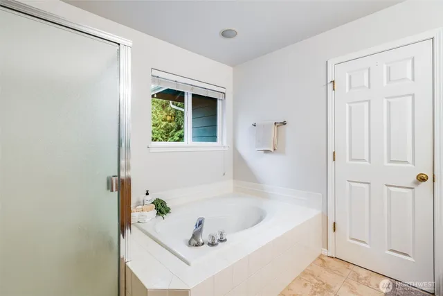 a white bath tub sitting next to a window